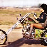 Motor Cycle Chick riding a chopper