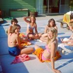 Teenagers enjoying a sunny summer day by the pool 70s